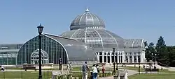 A one-story glass conservatory during daytime