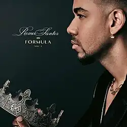 Romeo Santos holding a crown behind a dark-blue background